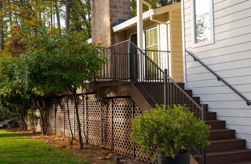 Elevated deck with waterproof decking surface and outdoor living space