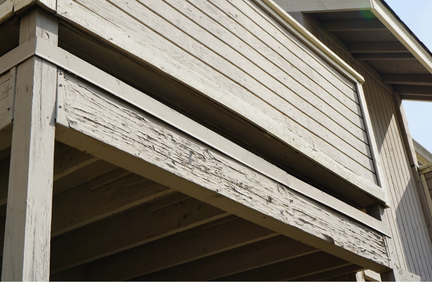 Softened and discolored wood beneath eaves, soffits, and roof overhangs