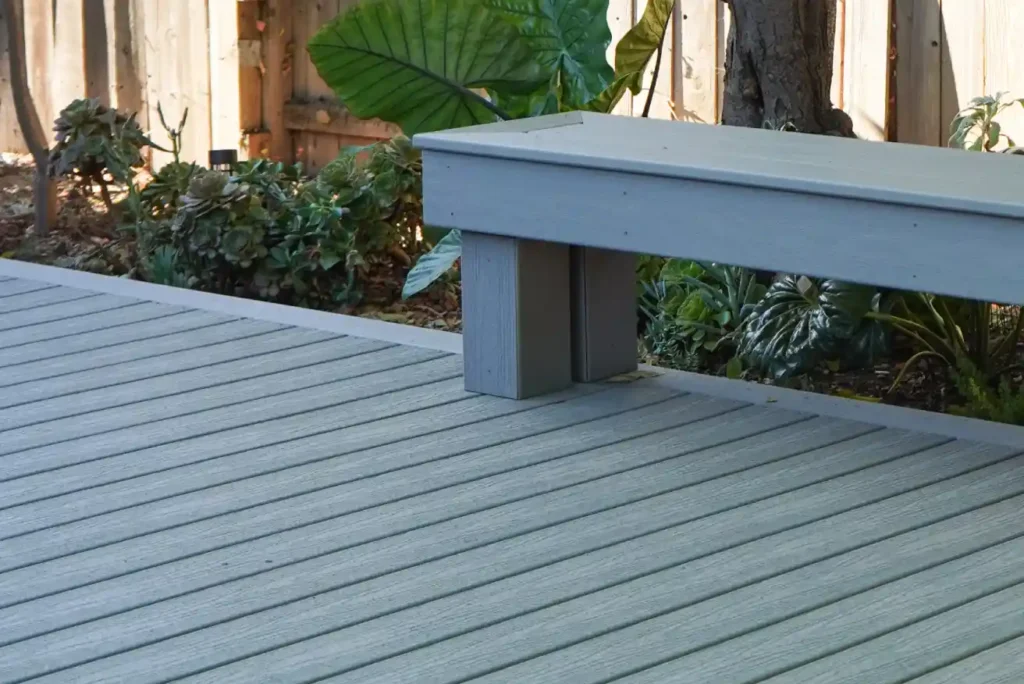 Homeowner comparing decking material samples on a Sacramento deck