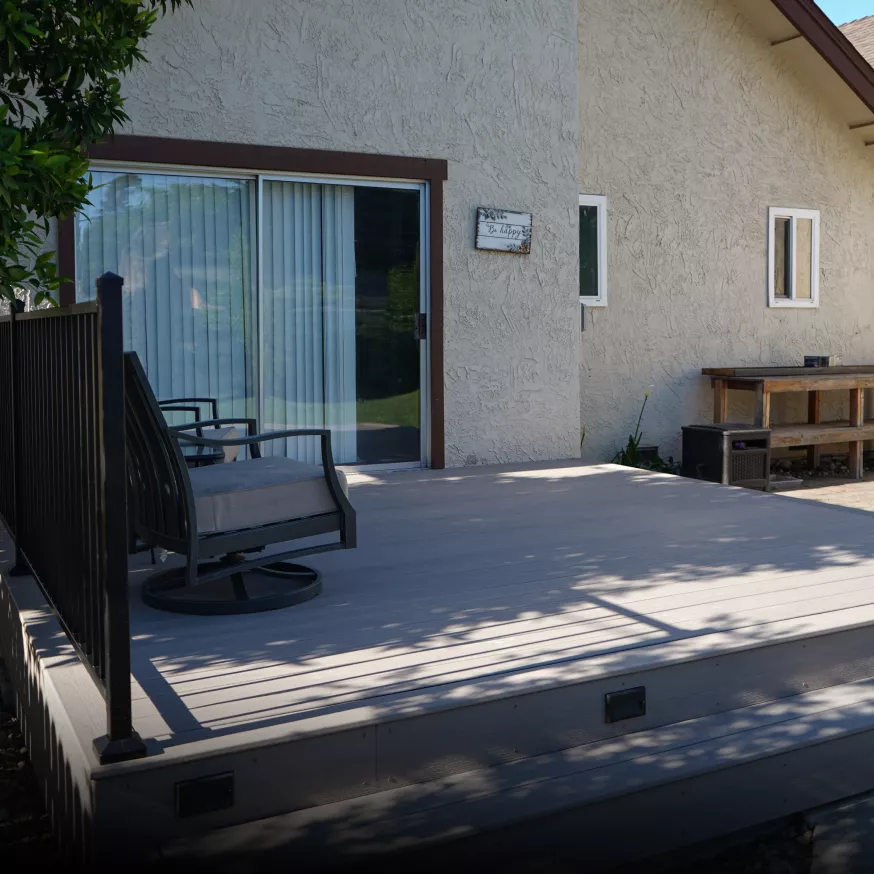 completed backyard with custom pergola, Trex composite deck, and integrated lighting