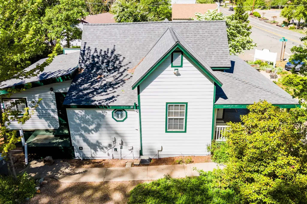 Two-story house with scaffolding Two-story home siding installation project