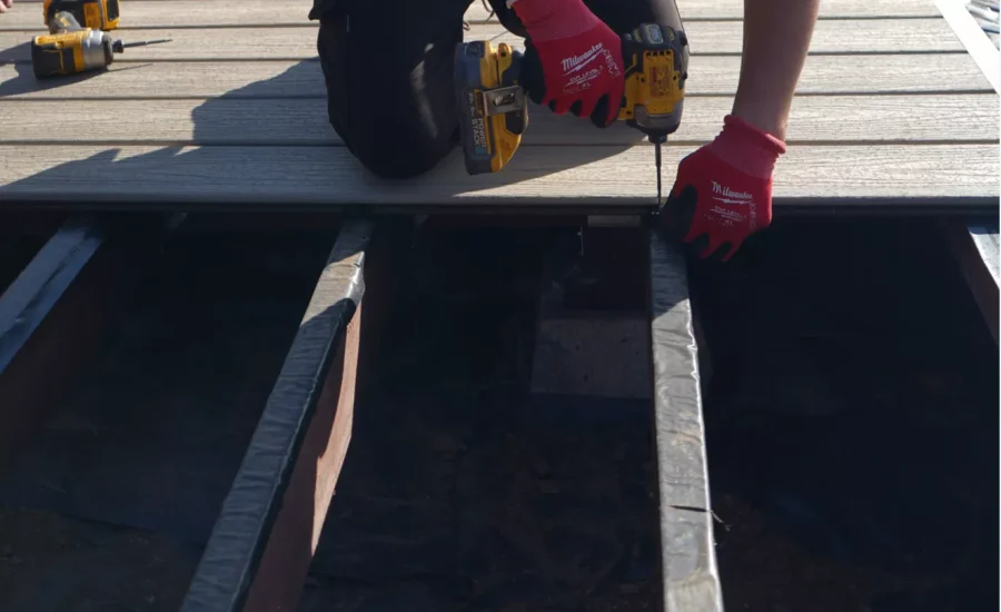 Workers removing old deck from a residential home