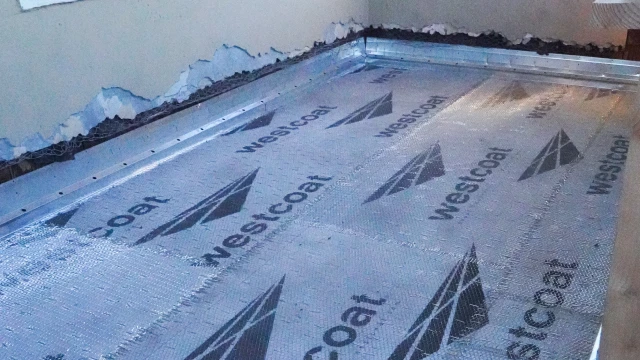 Waterproofed deck surface and stairs with sealed transitions to prevent moisture damage