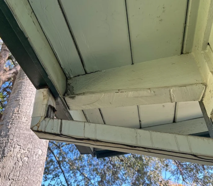 Deteriorated roof eave and soffit exposed before new James Hardie siding installation in Sacramento