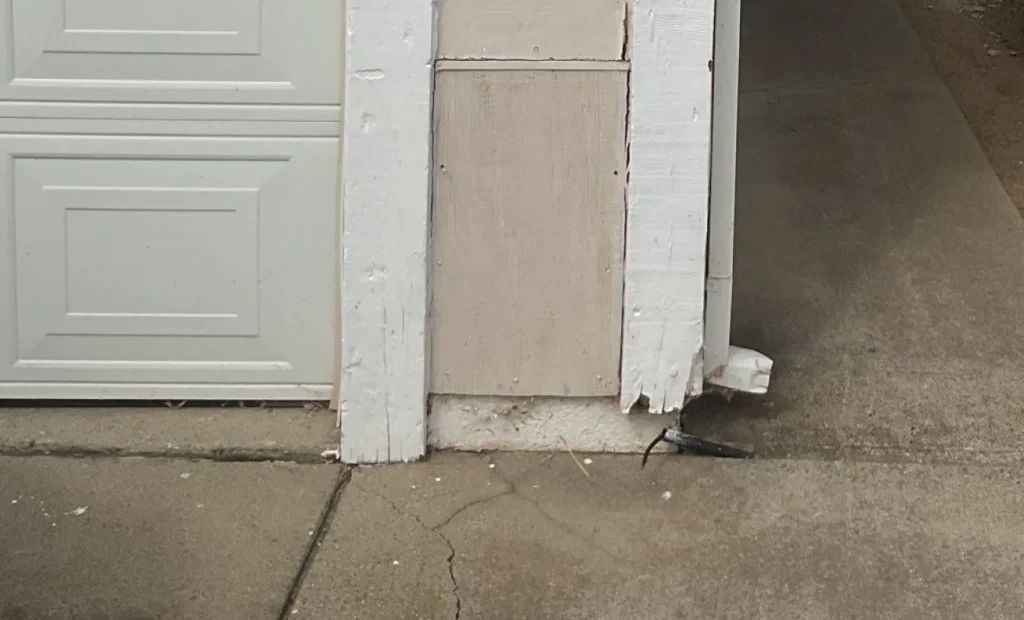 Resale value gains from new siding Close-up of cracked, peeling white paint and exposed rot on exterior wood trim beneath a roof or attic edge