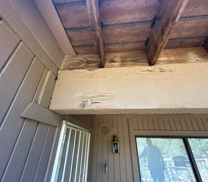 Damaged soffit and exposed wood discovered during James Hardie siding replacement in Sacramento, CA