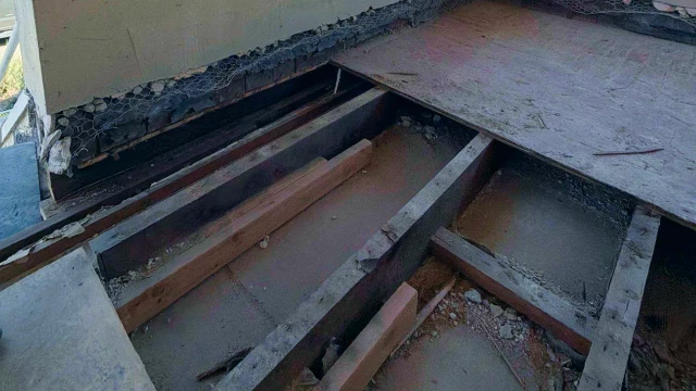 Pressure-treated wood deck under construction with visible framing