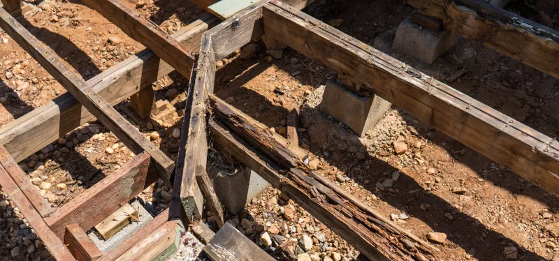  Damaged deck framing being repaired and replaced beneath an elevated deck structure