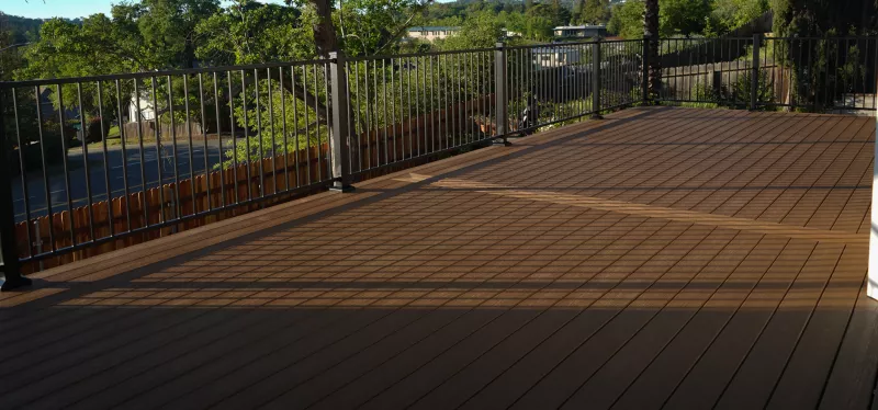 Before and after deck resurfacing with new boards and railing system