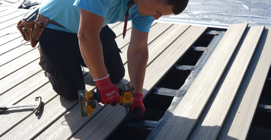 Contractor inspecting deck joists and ledger board during Roseville home assessment