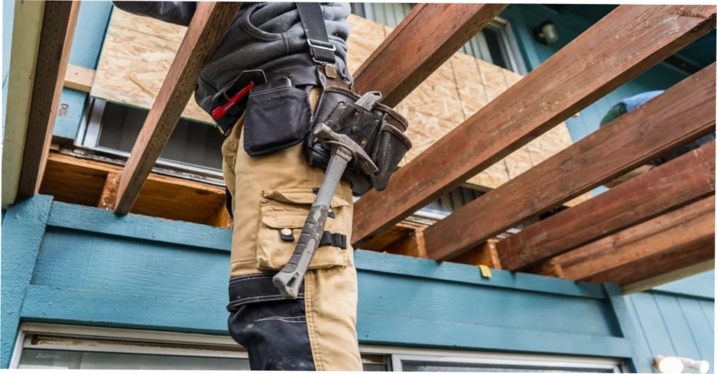 Contractor inspecting deck joists and ledger board for dry rot damage