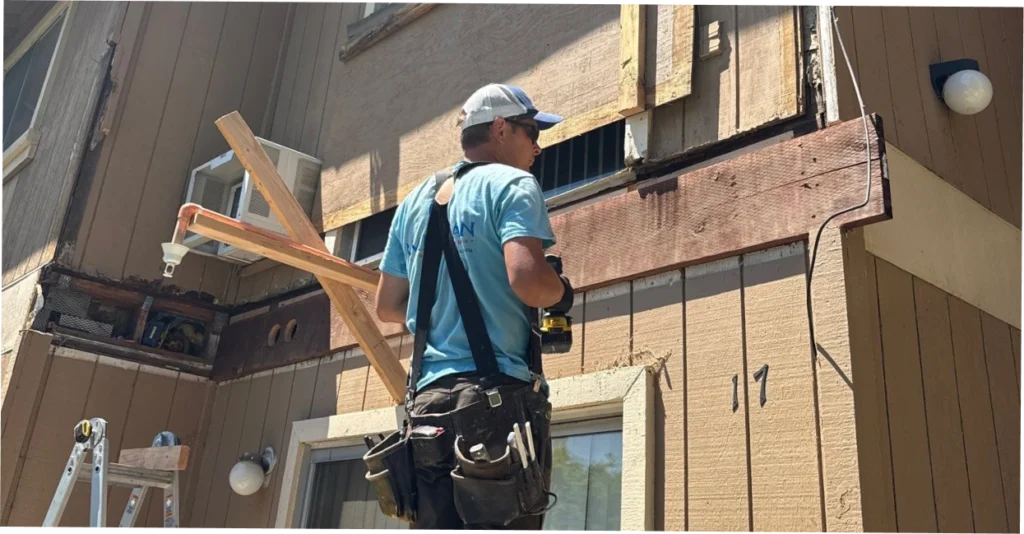 Contractor inspecting opened siding wall for hidden moisture damage on Folsom home