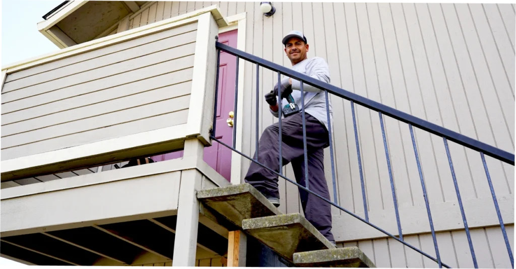 Siding contractor inspecting moisture damage behind cladding on a Rocklin home