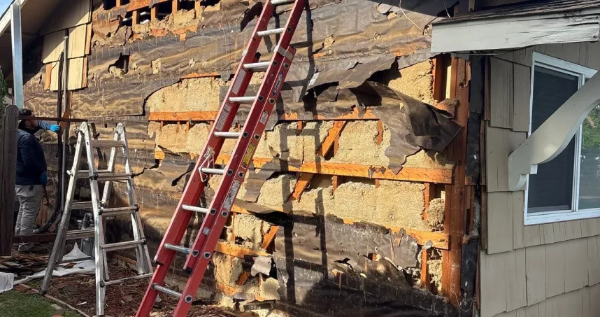 Existing wood siding being removed from North Highlands residential exterior.