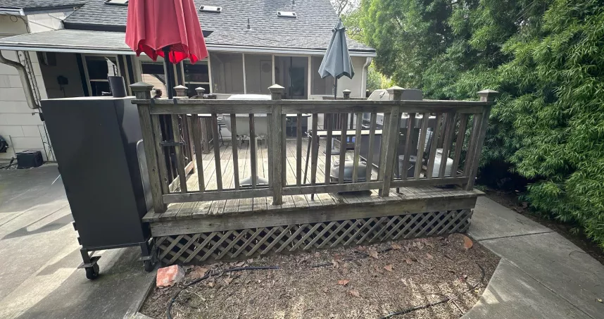 Rotted wood decking and damaged framing before removal.