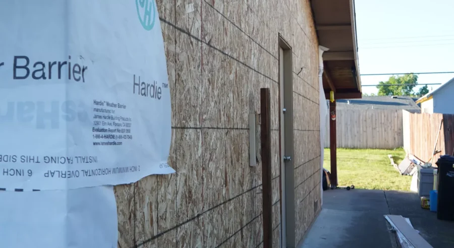 Old wood siding being removed from North Highlands house.
