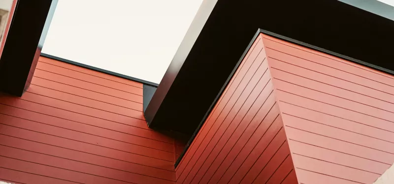 Composite engineered siding with wood-look texture on a home exterior