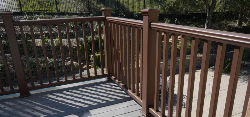 deck-board-and-railing-replacement Contractor replacing worn deck boards and railings on an existing backyard deck