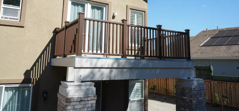 elevated-deck-waterproofing-system Waterproof membrane being installed on an elevated residential deck to prevent leaks