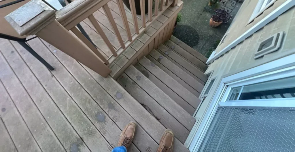 Deck contractor inspecting ledger board and framing on a Woodland home deck