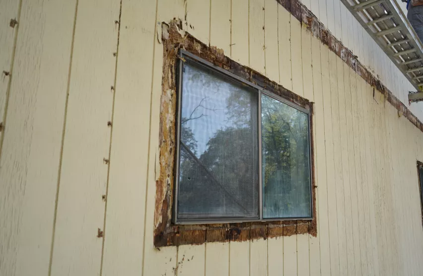 Elk Grove home window with rotted trim and damaged siding before replacement