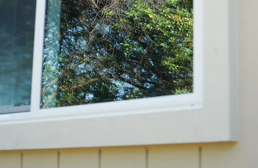 Repaired sill and new white trim around a replacement window in Folsom