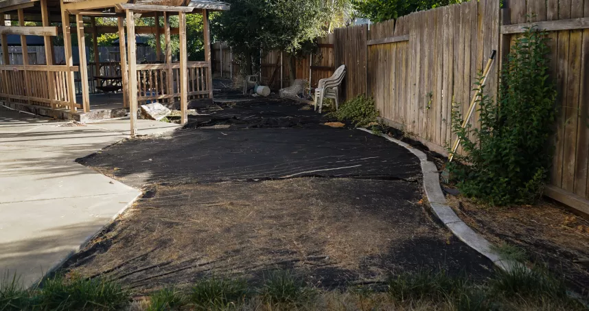 Empty residential outdoor space before construction of a small Trex deck in Sacramento.