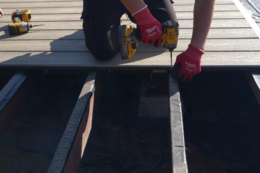 Trex composite deck boards being installed over newly built framing.