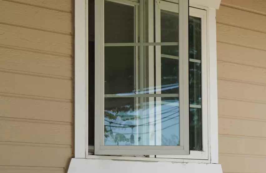 Original sliding window on a Roseville home before window replacement