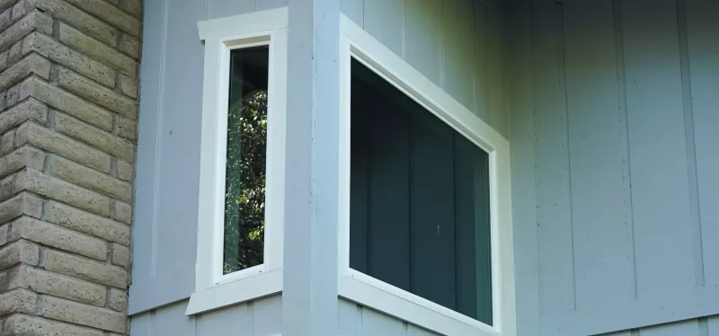 Awning window open above a kitchen counter alongside specialty arched and circular residential window designs
