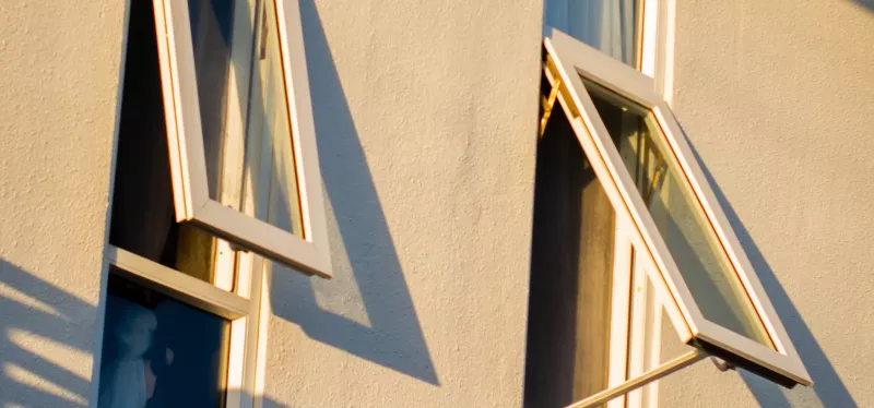 Awning window hinged at top tilting outward