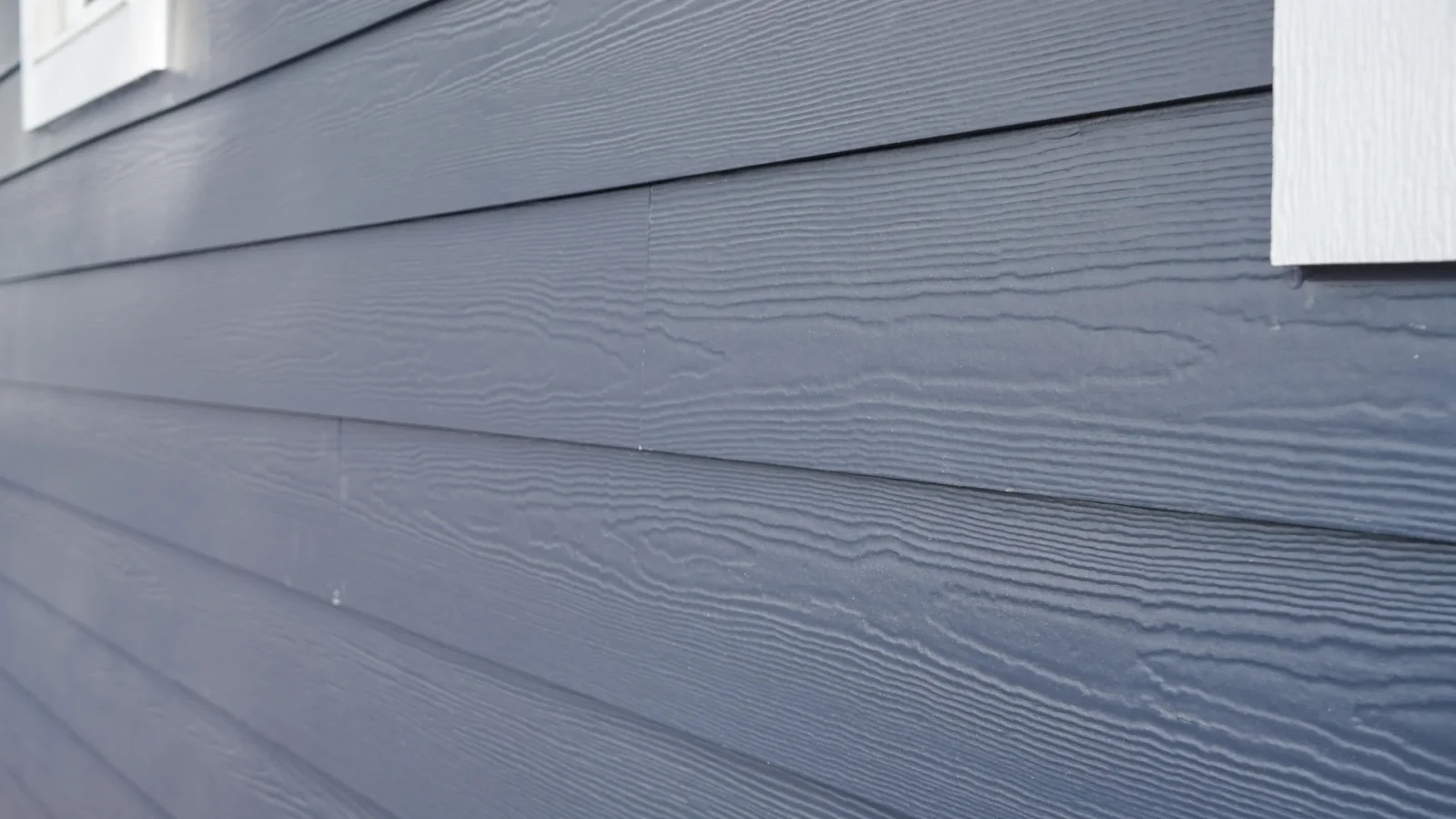 Close-up of smooth blue James Hardie ColorPlus fiber cement siding.