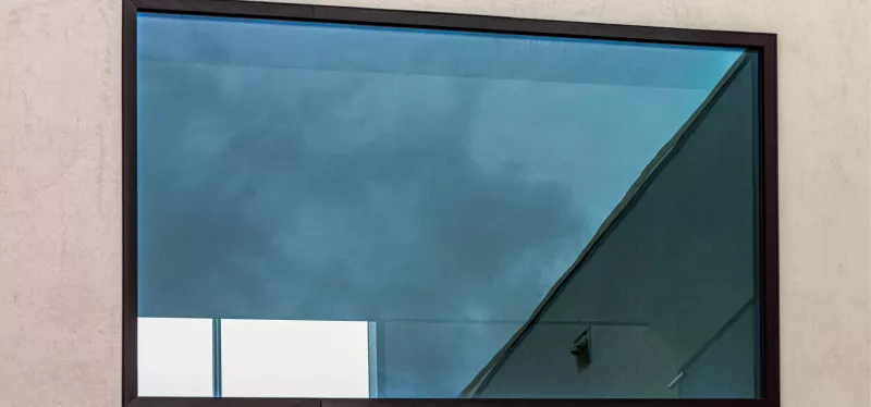 Large fixed picture window bringing natural light into a living room