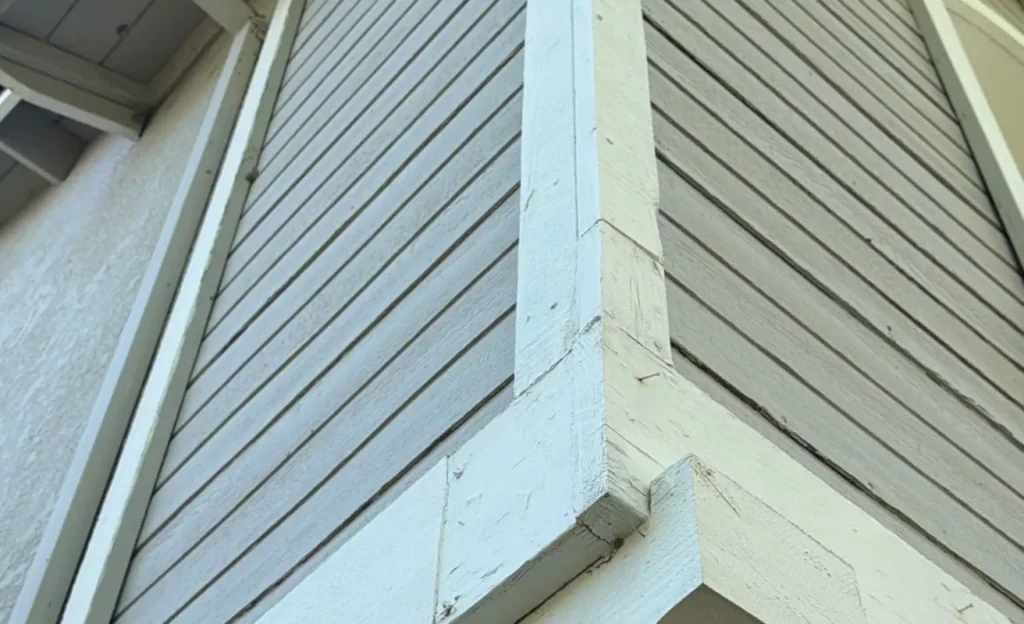Flashlight beam on cut siding edge revealing brown fibers